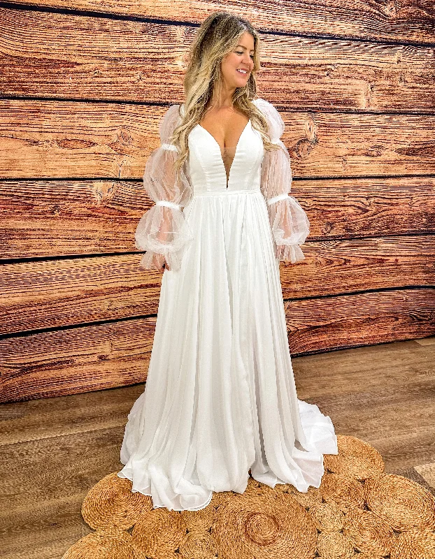 Cape - backed wedding dress for a dramatic entranceClara Wedding Dress