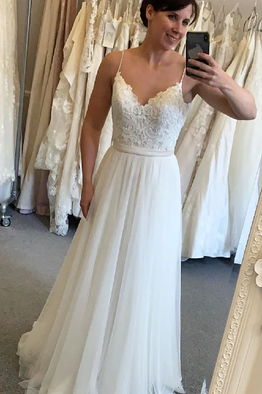 Fit - and - flare wedding dress with a big bowLong A-line Spaghetti Strap Ivory Wedding Dress with Lace